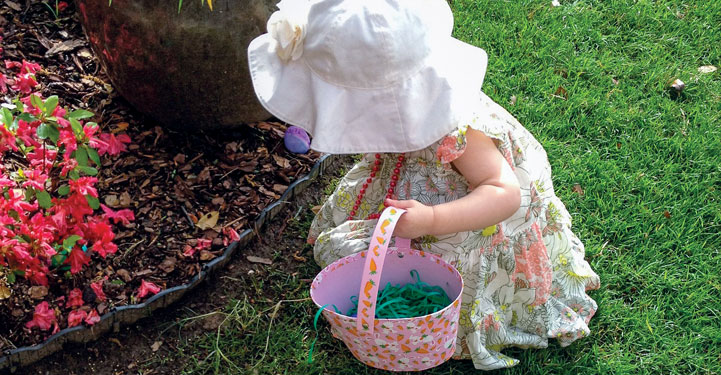 Petite fille en train de chercher les œufs de Pacques
